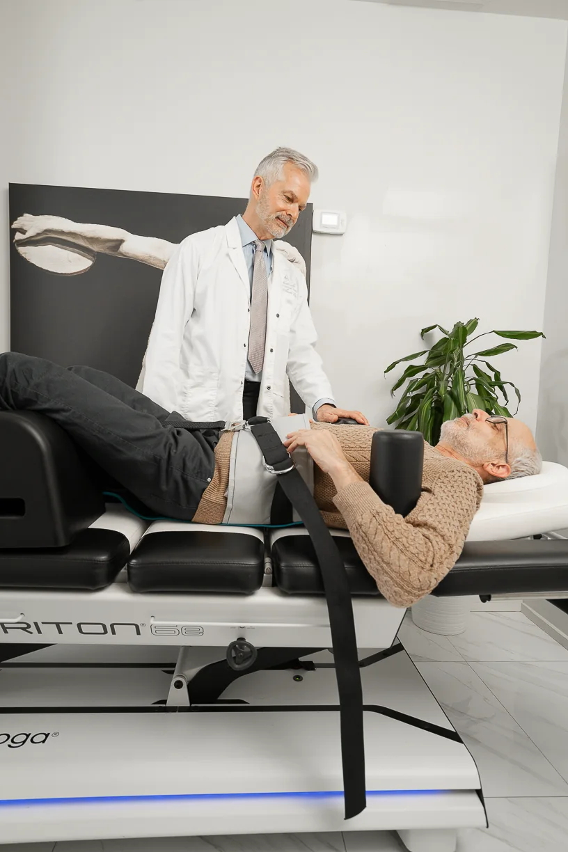 A Yorkville Sports Medicine physician securing a patient on the decompression table