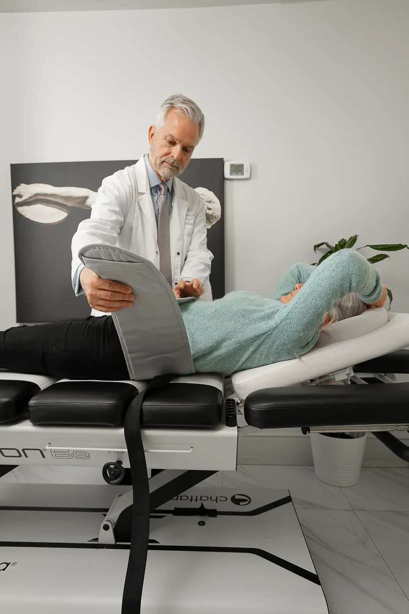 A Yorkville physician fitting the lumbar support before decompression